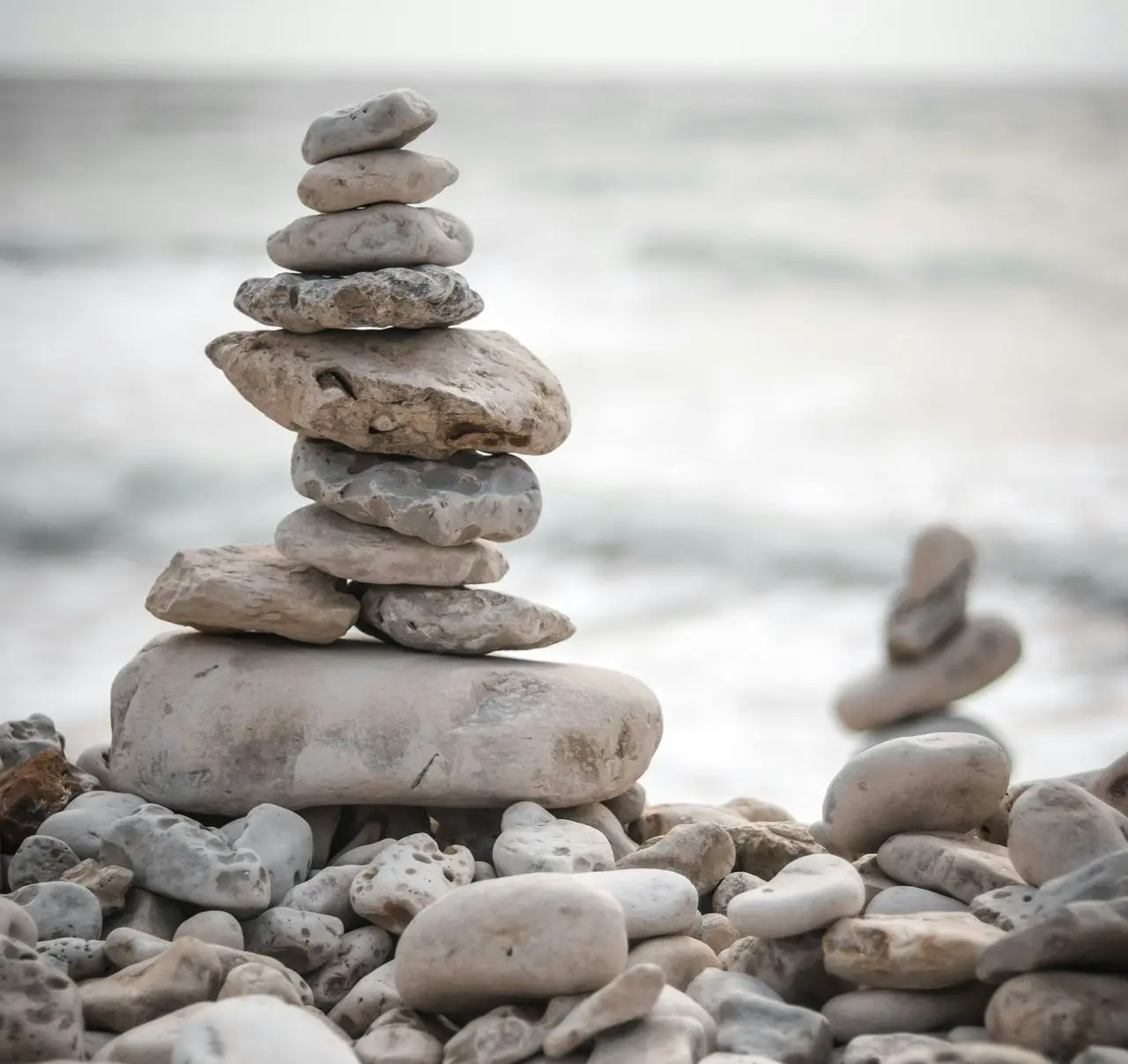 a pile of rocks sitting on top of a beach